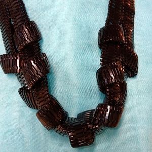 3-10-2 Black and goldtone braided necklace in good condition.